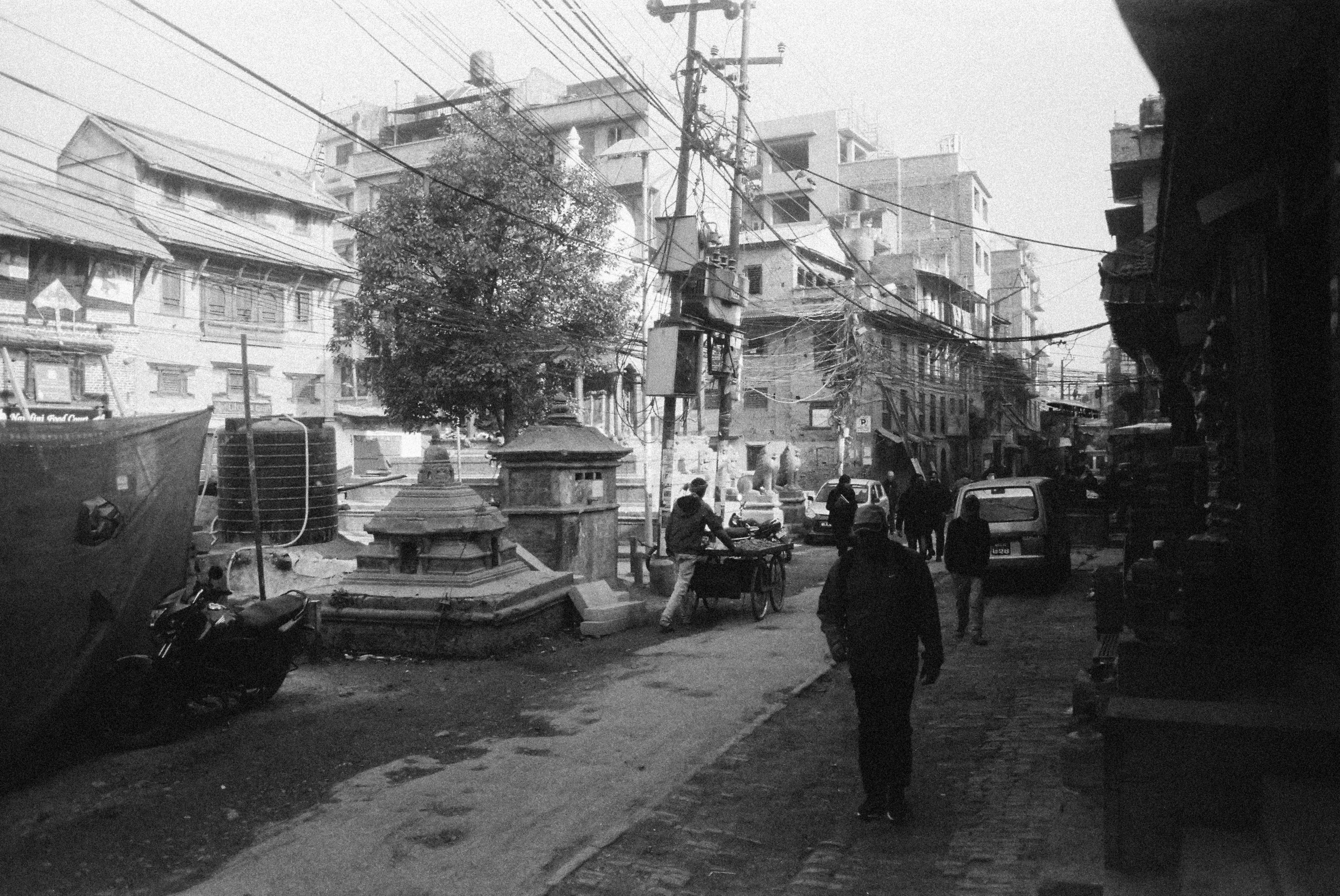 grayscale photo of people walking on street